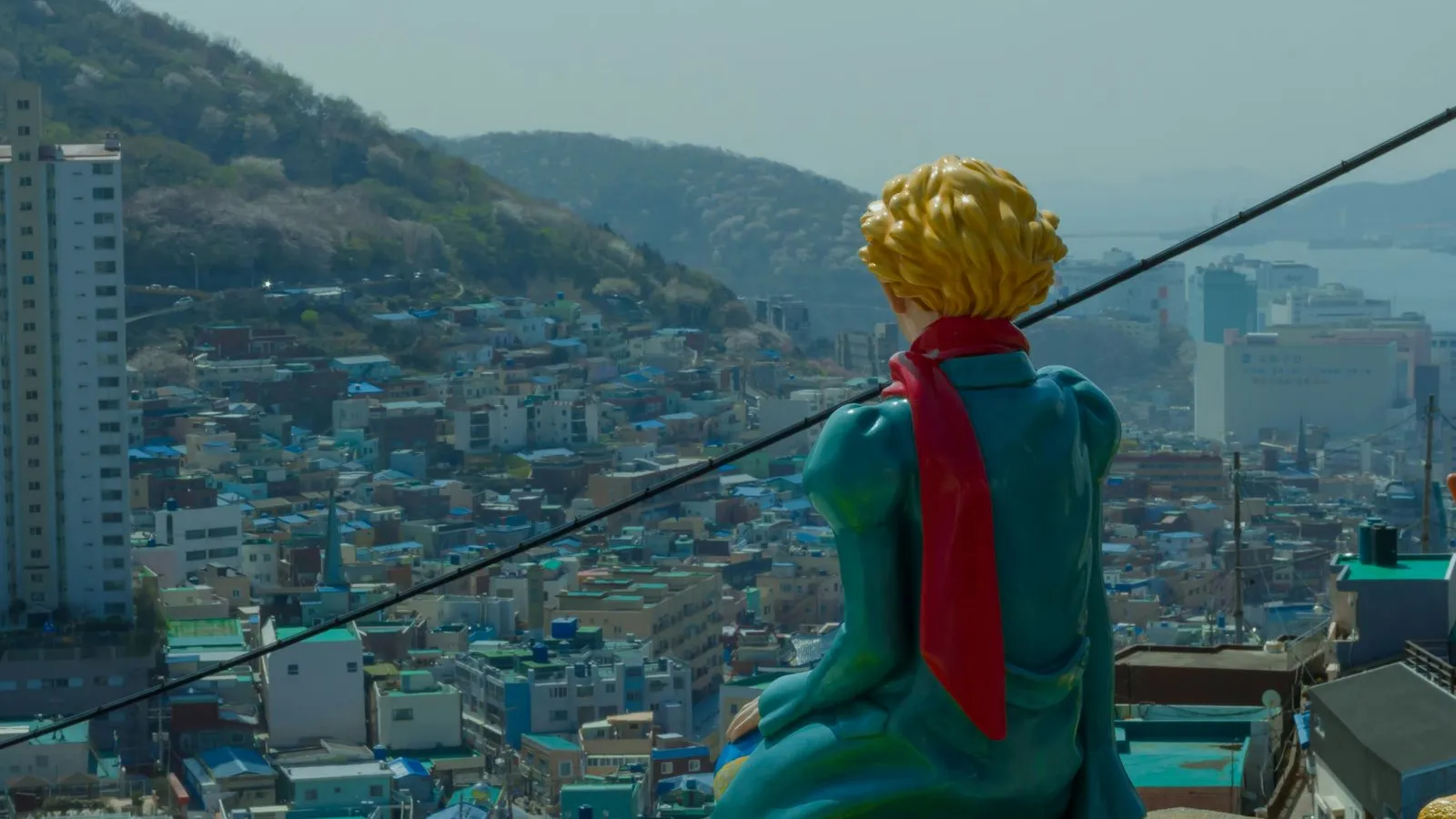 The Little Prince statue overlooking the colorful hillside houses of Gamcheon Culture Village