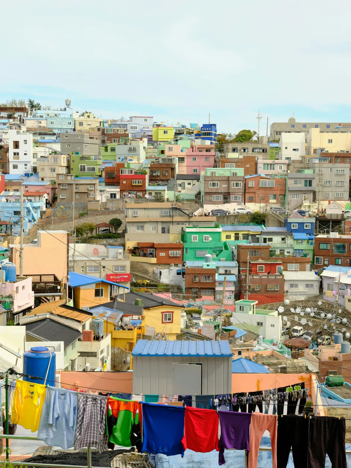 Colorful terraced houses of Gamcheon Culture Village, with laundry hanging from a rooftop line
