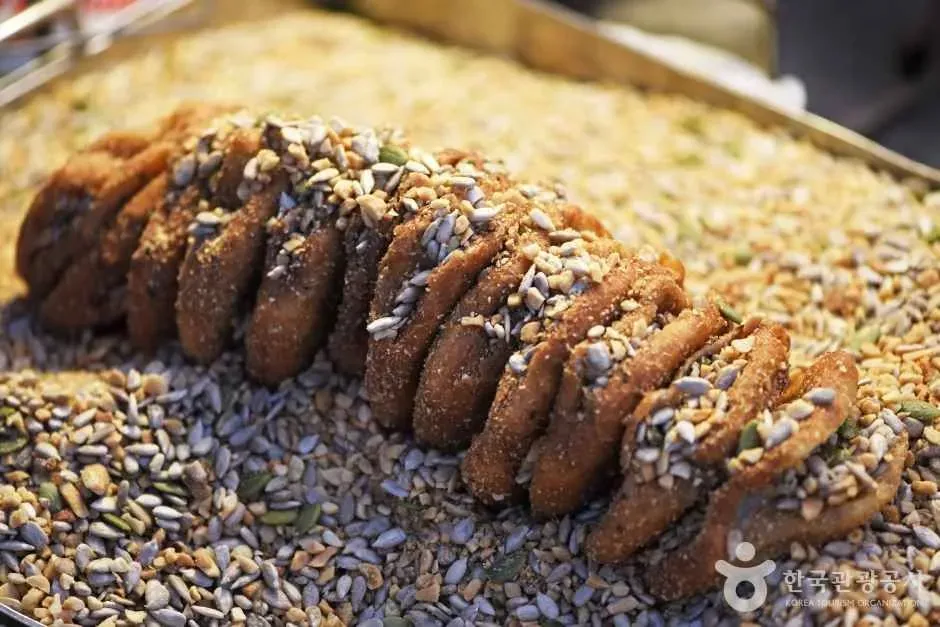 A golden, crisp ssiat hotteok stuffed with seeds and syrup