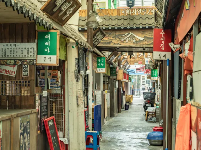 Shop signs lining an alley in Gukje Market